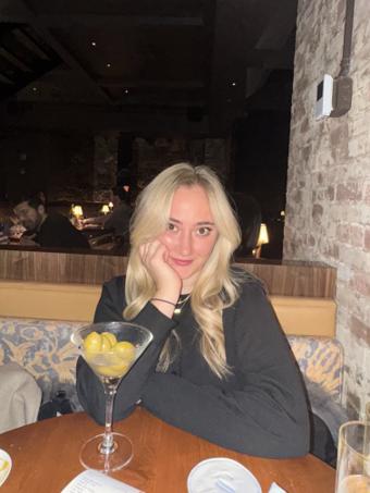 Isabella Scarselli of Hala, at a restaurant banquette with a martini