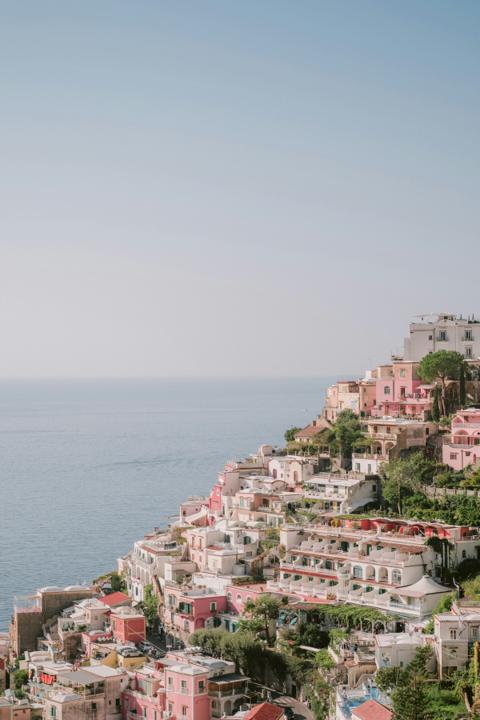 Positano stacked pink and white down the cliff, the Tyrrhenian flat and pale behind it