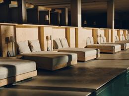Forestis Dolomites — spa relaxation loungers in soft pine cabanas above the indoor pool