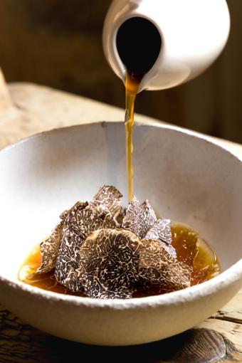 La Stüa de Michil — shaved black truffle in a bowl with broth poured over
