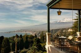 Belmond Grand Hotel Timeo — view of snow-capped Mount Etna over the Ionian coastline from a hotel terrace