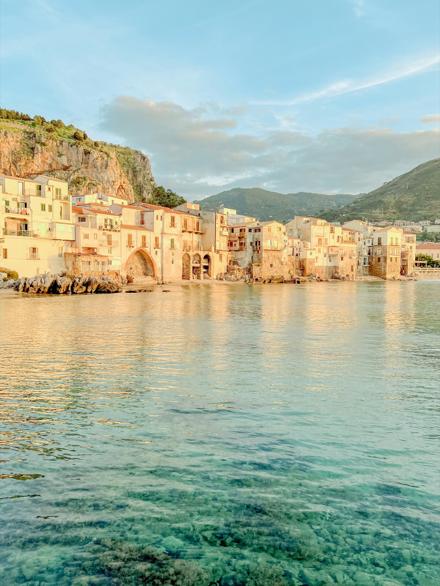 An old town built down to the water, the shallows clear in the late light