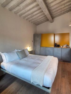 La Bandita Townhouse — Junior Suite with wood-beam ceiling