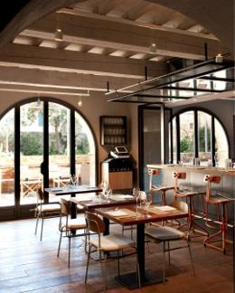 La Bandita Townhouse — Townhouse Caffè interior with arched windows and dining tables