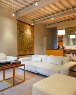 La Bandita Townhouse — library lounge with large vintage Italy map and white sofas