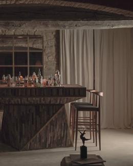 Vocabolo Moscatelli — the Matite cocktail bar, sculptural wood-faced counter under a brick vault