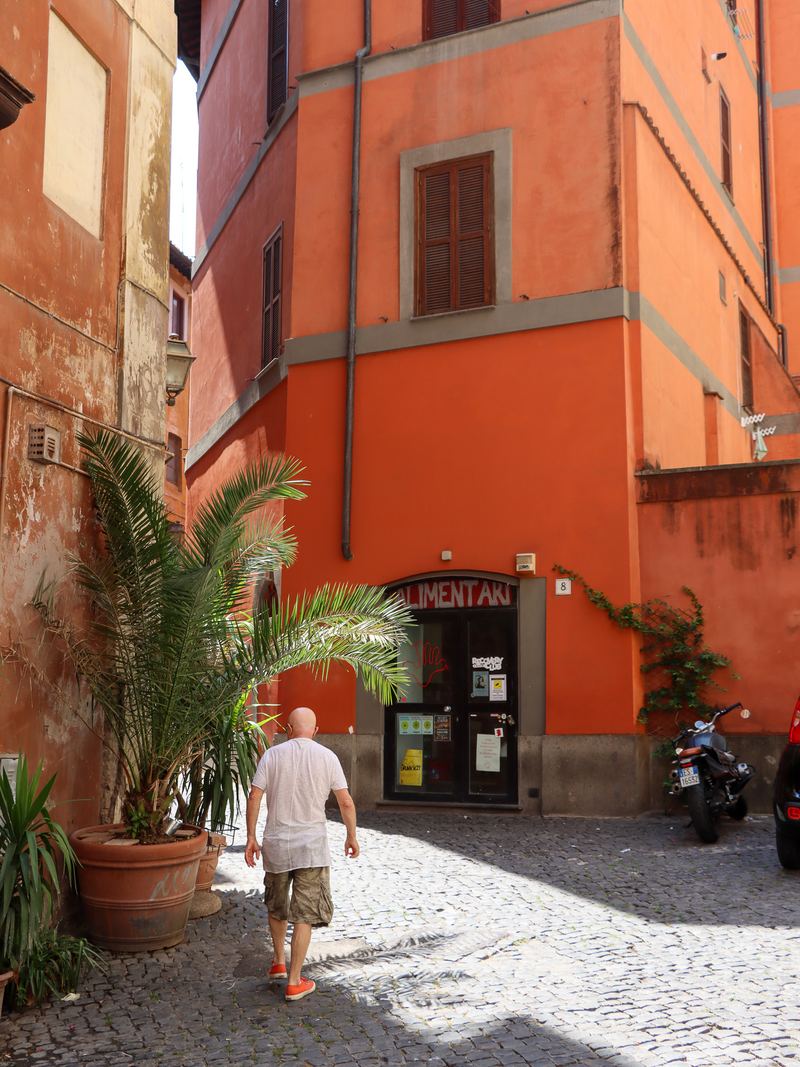 Cobblestone alley in Rome with orange buildings