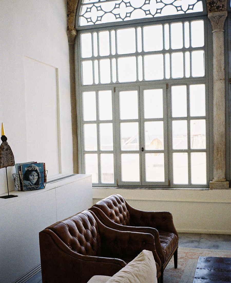 Efendi Hotel interior, Acre — leather chairs and arched window