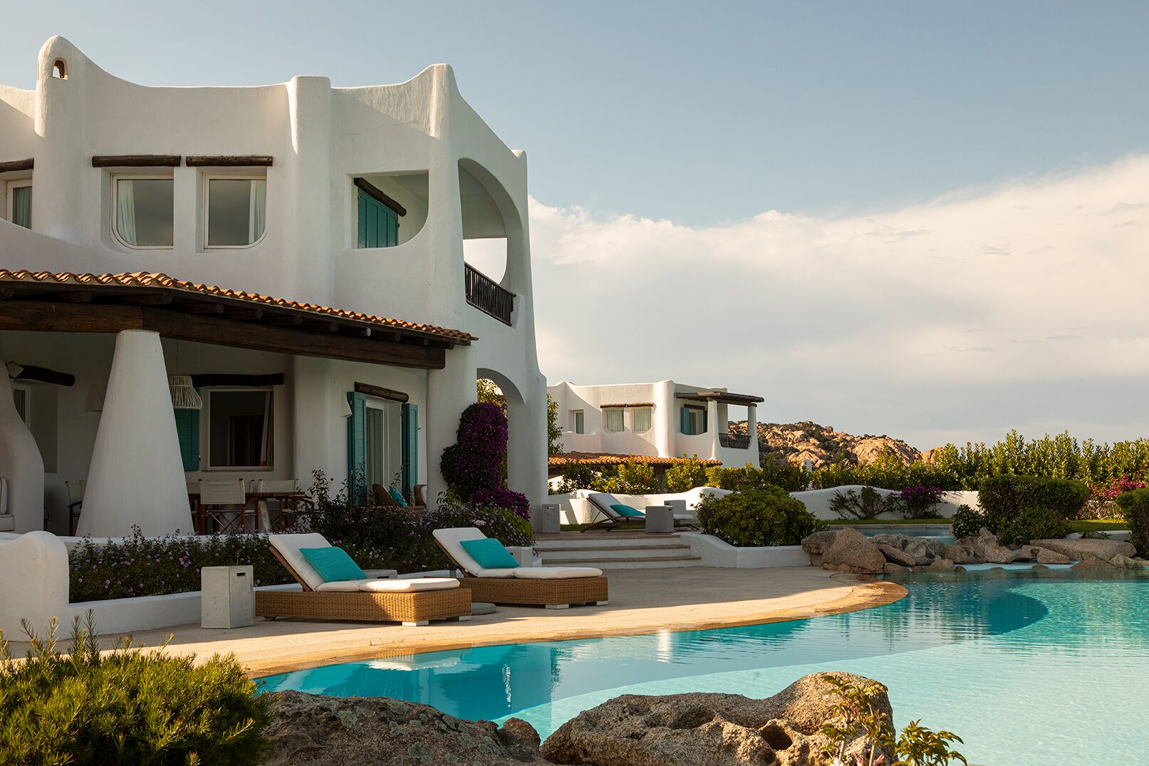 Romazzino — private villa with infinity pool, sculptural white exteriors, bougainvillea