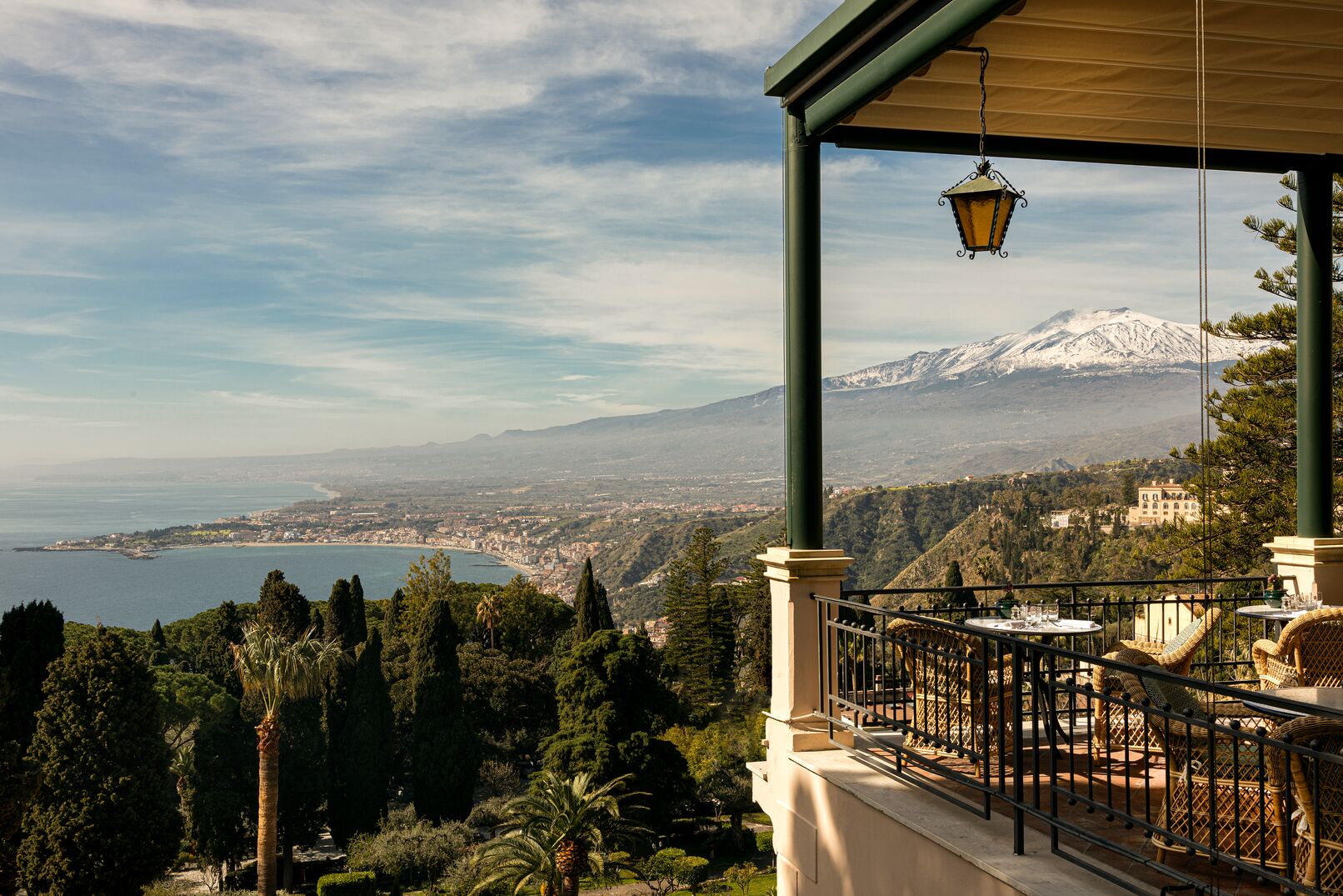 Belmond Grand Hotel Timeo — view of snow-capped Mount Etna over the Ionian coastline from a hotel terrace