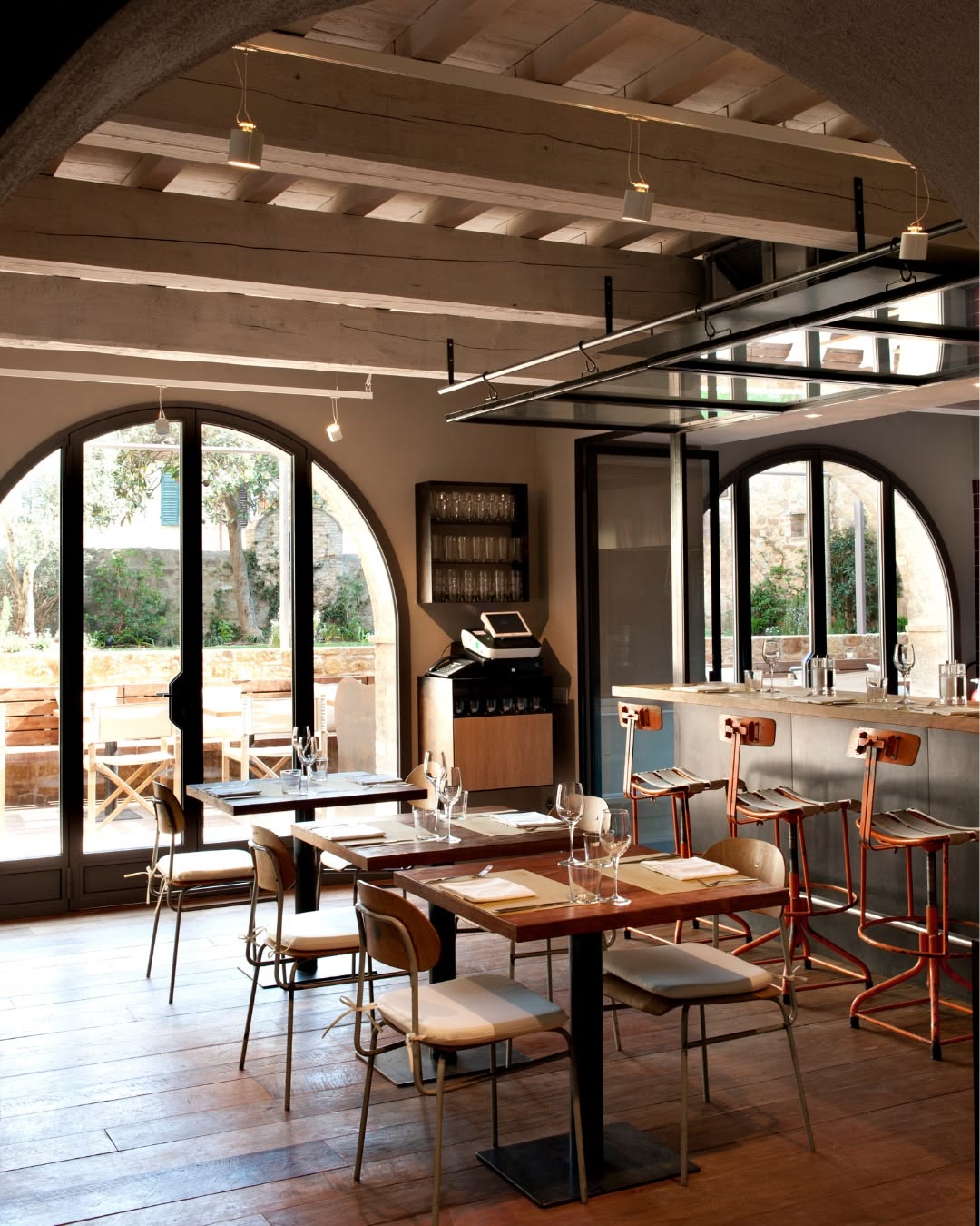 La Bandita Townhouse — Townhouse Caffè interior with arched windows and dining tables