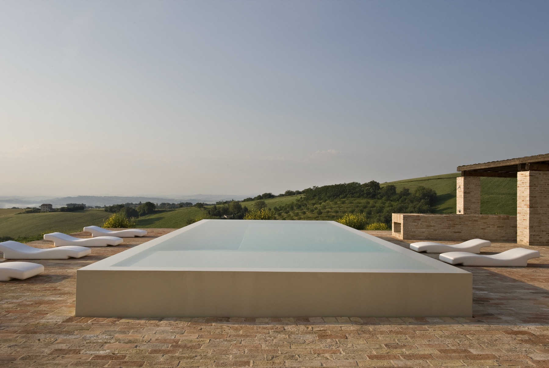 Casa Olivi — infinity pool terrace looking out across the Marche hills