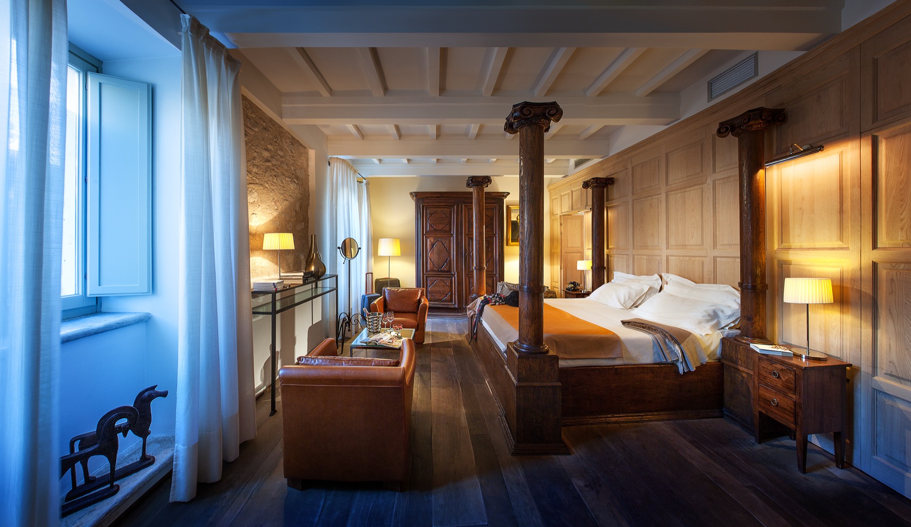 Palazzo Seneca — Junior Suite with four-poster wood-panelled bed and antique writing desk